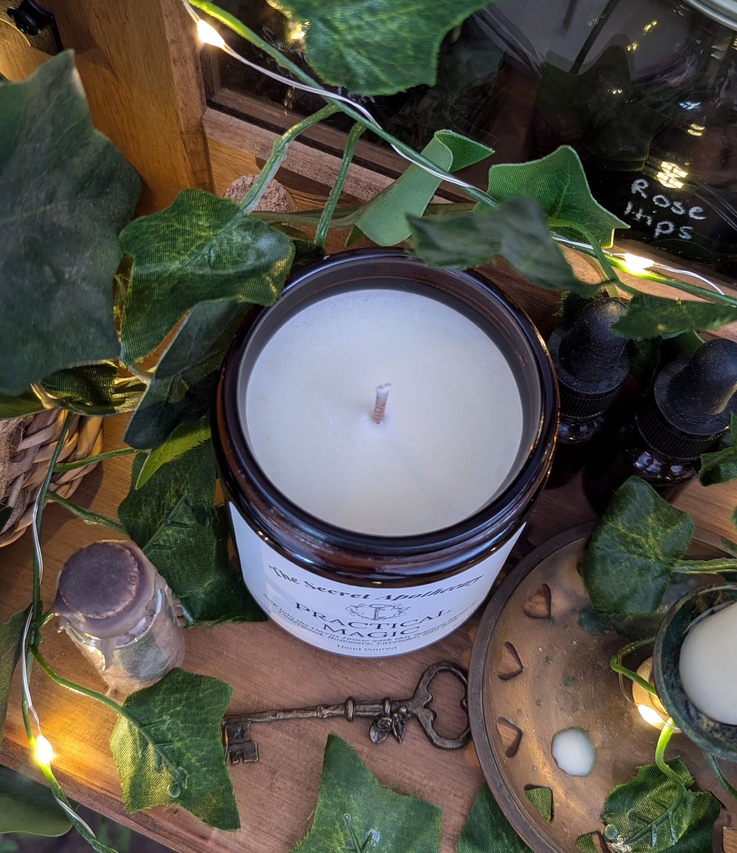 Practical Magic Luxury Scented Candle - 100% organic soy wax with premium essential oils in amber glass jar.