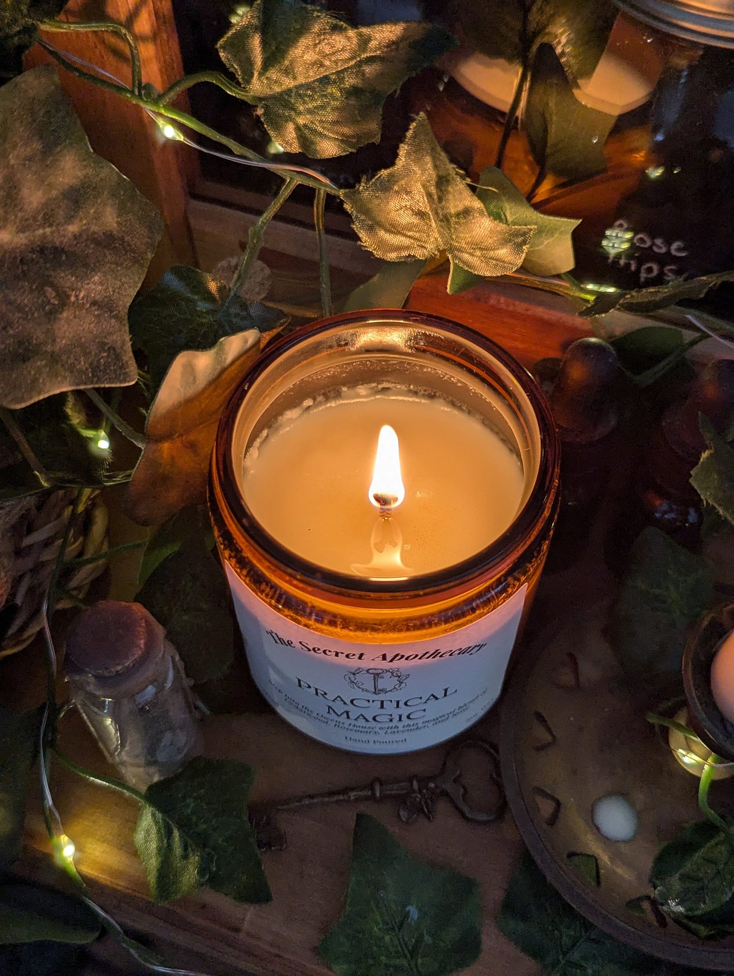 Practical Magic Luxury Scented Candle - 100% organic soy wax with premium essential oils in amber glass jar.