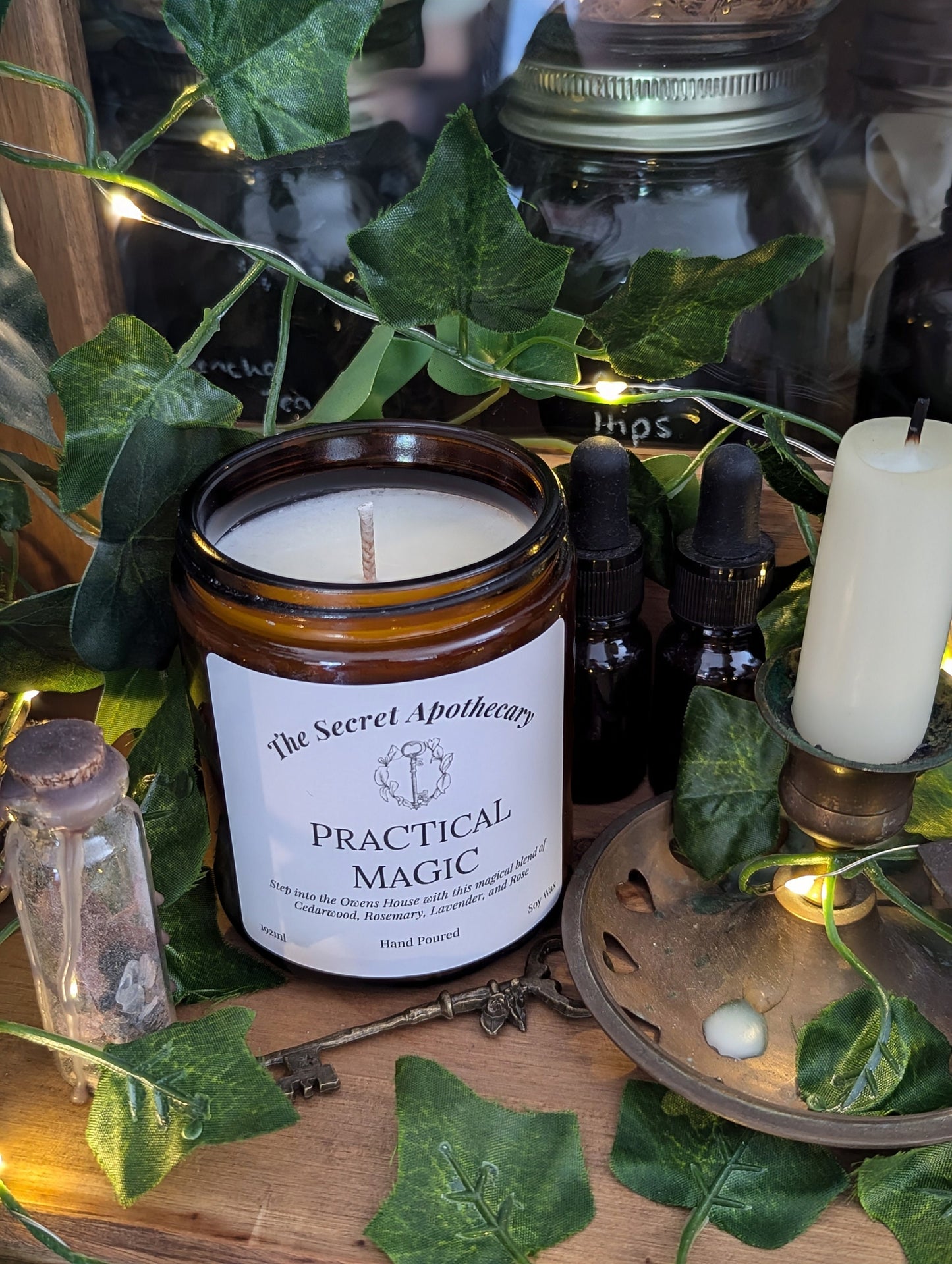 Practical Magic Luxury Scented Candle - 100% organic soy wax with premium essential oils in amber glass jar.