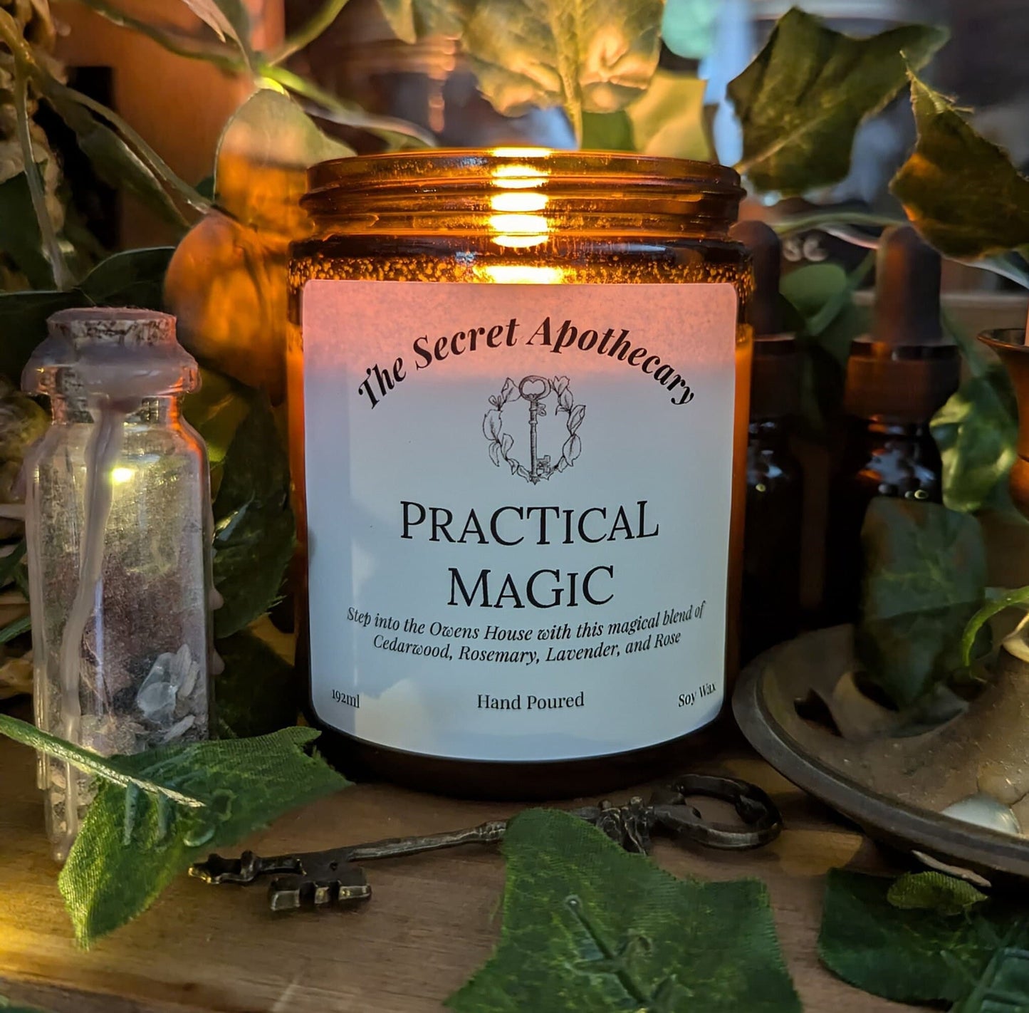 Practical Magic Luxury Scented Candle - 100% organic soy wax with premium essential oils in amber glass jar.