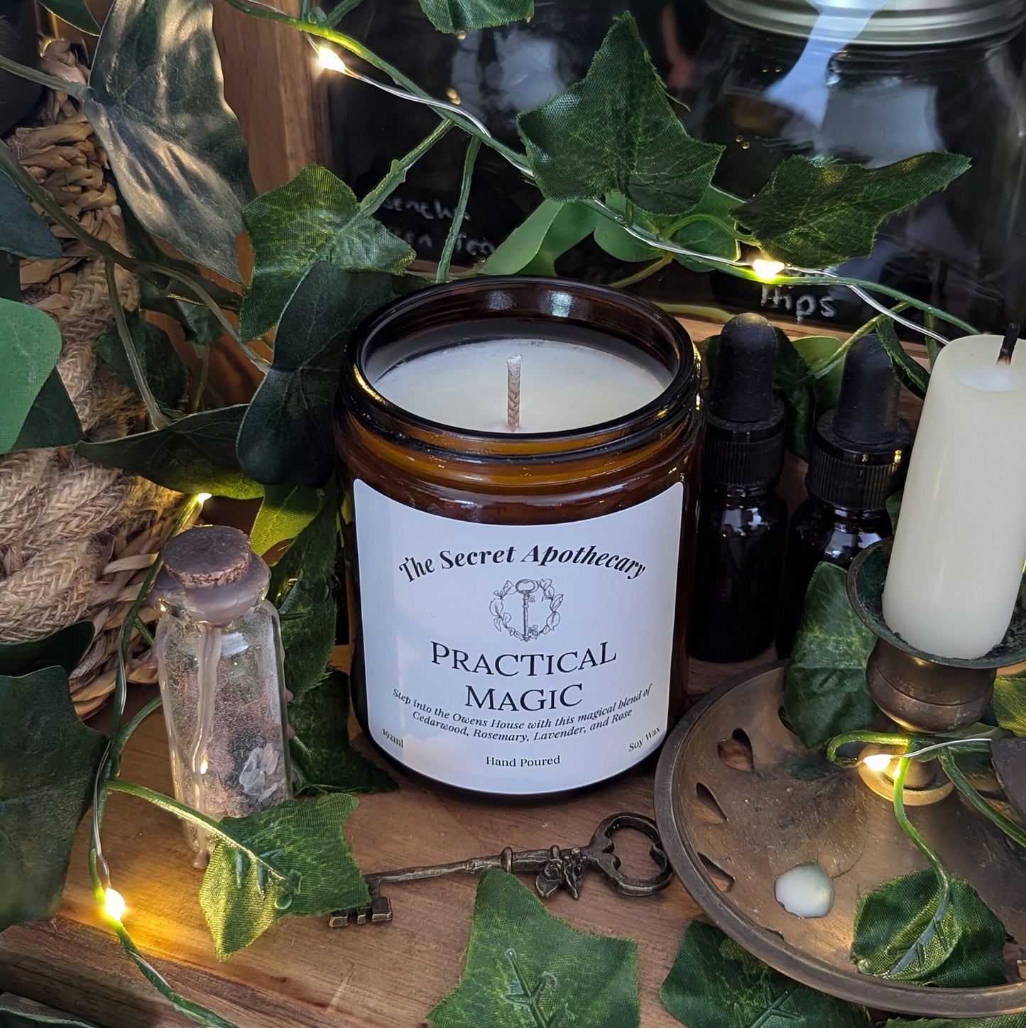 Practical Magic Luxury Scented Candle - 100% organic soy wax with premium essential oils in amber glass jar.
